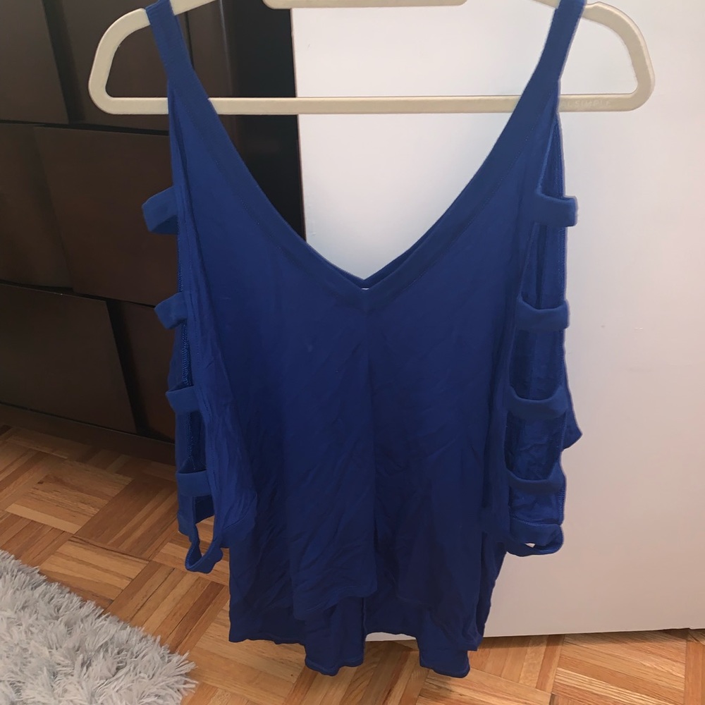 Shirt with sleeve cut outs